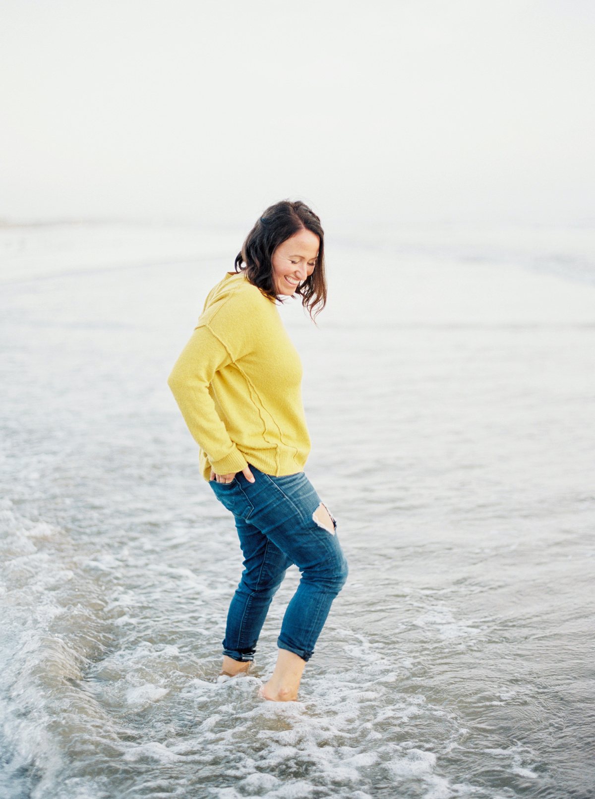 Talkeetna Wedding Photographer Winston Photography standing in the ocean by Loveridge Photography